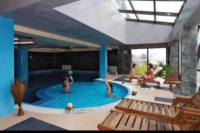 a group of people in a swimming pool at Lovely private apartment in Belelvedre in Bansko