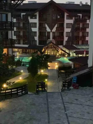 a view of a city at night with buildings at Lovely private apartment in Belelvedre in Bansko