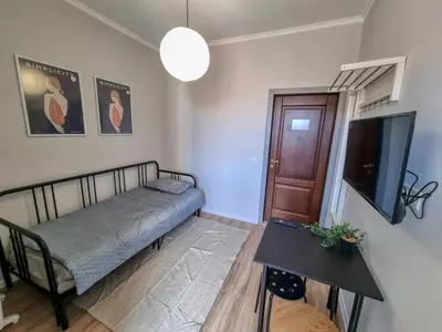 a bedroom with a bed and a tv and a table at Comfortable Studio in Sofia City in Sofia