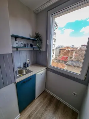 a small kitchen with a sink and a window at Comfortable Studio in Sofia City in Sofia