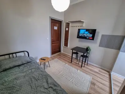 a bedroom with a bed and a table and a television at Comfortable Studio in Sofia City in Sofia