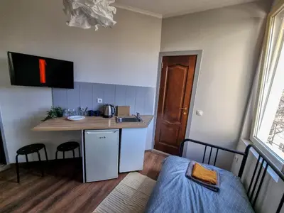 a small kitchen with a sink and a table at Relaxing Studio in Sofia Center in Sofia