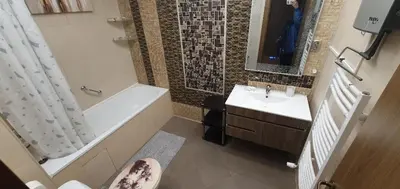 a bathroom with a sink and a tub and a toilet at Harriet Hill Designer Bansko in Bansko