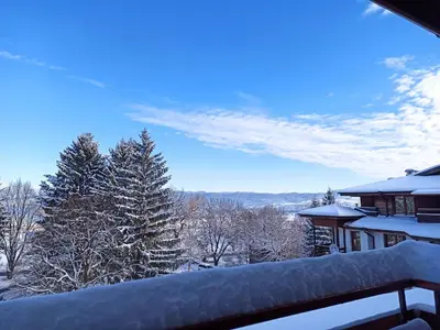 a view from the balcony of a house in the snow at VV Apartment Bansko in Bansko