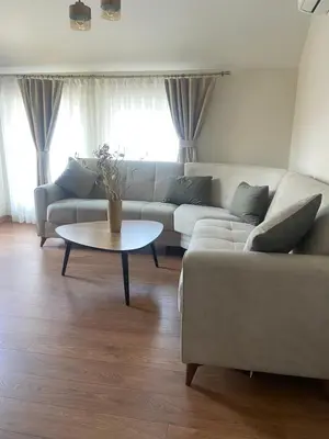a living room with a couch and a table at M&M Center Apartment with free parking in Plovdiv