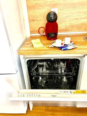a microwave oven with a wooden counter top with cups on it at M&M Center Apartment with free parking in Plovdiv
