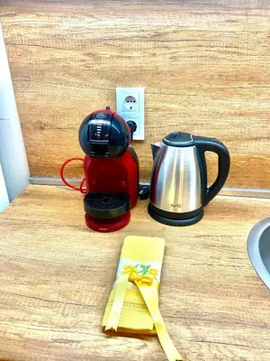 a coffee maker and a tea kettle on a counter at M&M Center Apartment with free parking in Plovdiv