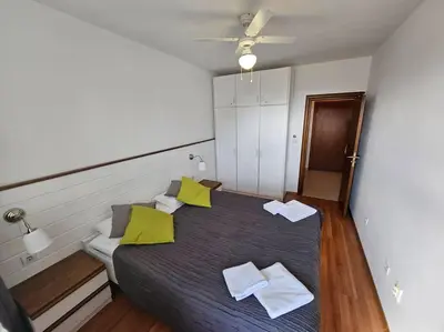 a bedroom with a large bed with yellow pillows at Bansko Private VIP Apartment in Bansko
