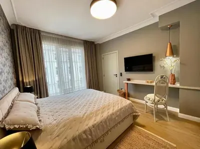 a bedroom with a bed and a desk and a television at Luxury 2 Bedroom Top Central Apartment in Sofia