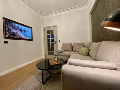 a living room with a couch and a table at Luxury 2 Bedroom Top Central Apartment in Sofia