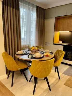 a dining room table with yellow chairs in a kitchen at Luxury 2 Bedroom Top Central Apartment in Sofia