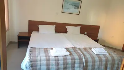 a bedroom with a bed with two towels on it at Rositsa 28 in Pamporovo