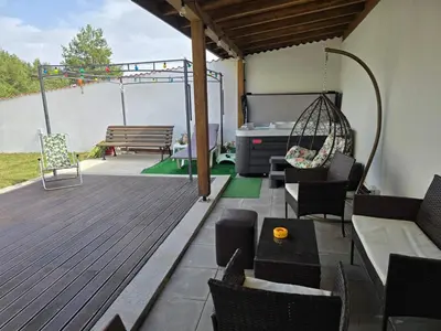 a patio with a hammock and a swing at Къща за гости Замък Никола in Shtarkelovo Gnezdo