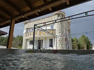 a building that is sitting on top of water at Къща за гости Замък Никола in Shtarkelovo Gnezdo