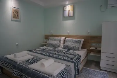 a bedroom with a bed with two towels on it at DaRoom in the heart of Plovdiv in Plovdiv