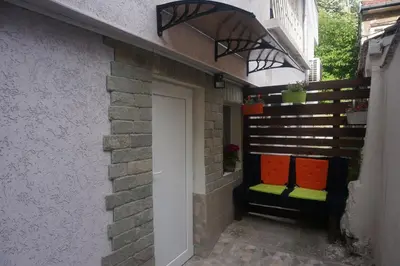 a door leading into a building with two benches at DaRoom in the heart of Plovdiv in Plovdiv