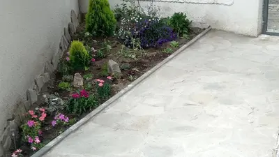 a garden with flowers next to a building at DaRoom in the heart of Plovdiv in Plovdiv