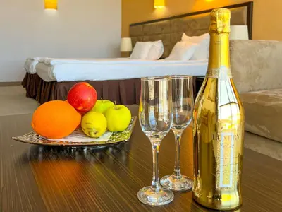 a bottle of champagne and two glasses on a table at Hotel Dream in Sofia