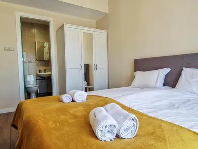 a bedroom with a bed with towels on it at Cozy 2BD Apartment in Bansko by Flat Mаnager in Bansko