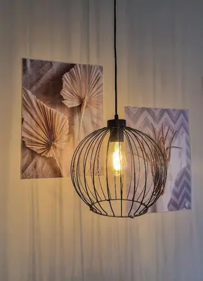 a hanging cage light in a room with some pictures at Cozy 2BD Apartment in Bansko by Flat Mаnager in Bansko