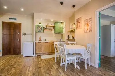 a kitchen and dining room with a table and chairs at Cozy 2BD Apartment in Bansko by Flat Mаnager in Bansko