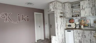 a kitchen with wooden cabinets and a white microwave at Kiki Home in Blagoevgrad