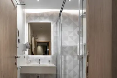 a bathroom with a sink and a shower at City Park Inn - Art Gallery in Plovdiv