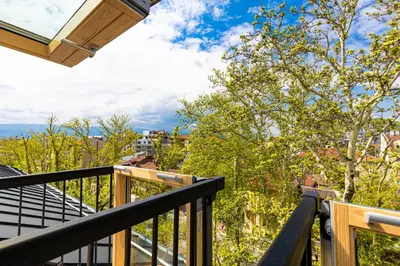 a balcony with a view of trees at Industrial-style 2BD Loft with Parking Spot by Flat Mаnager in Plovdiv