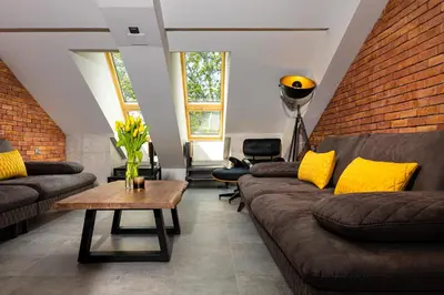 a living room with couches and a brick wall at Industrial-style 2BD Loft with Parking Spot by Flat Mаnager in Plovdiv