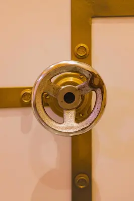 a metal doorhandle on a door with a cross at Hidden Bank: Pearls in Plovdiv
