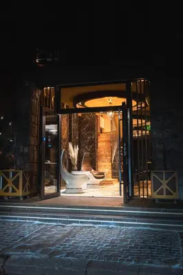 a glass door of a building with a chair in it at Hidden Bank: Pearls in Plovdiv