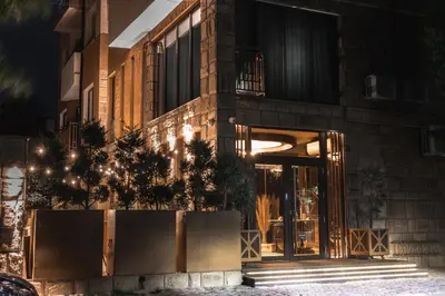 a building with a glass door at night at Hidden Bank: Pearls in Plovdiv