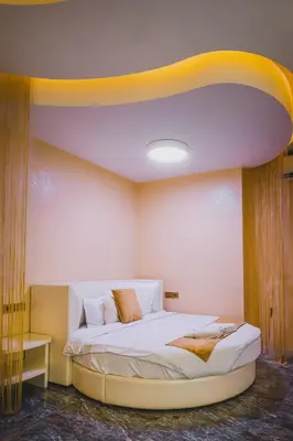 a bedroom with a bed with a yellow ceiling at Hidden Bank: Pearls in Plovdiv
