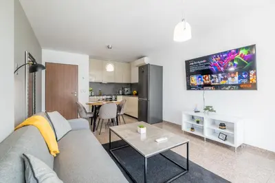 a living room with a couch and a table at Modern Apartment 3 with Parking next to Bulgaria Mall in Sofia