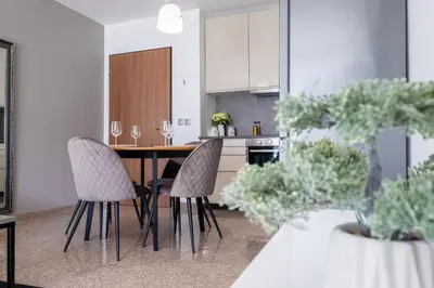 a kitchen with a dining room table and chairs at Modern Apartment 3 with Parking next to Bulgaria Mall in Sofia