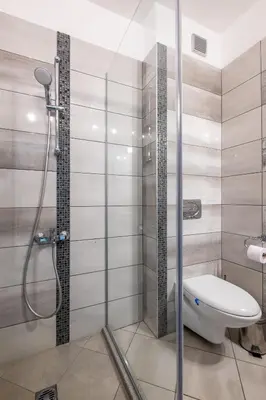 a bathroom with a shower and a toilet at Modern Apartment 3 with Parking next to Bulgaria Mall in Sofia