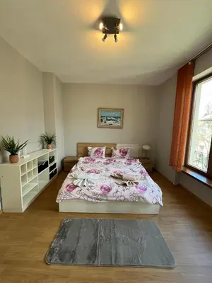 a bedroom with a large bed with pink sheets at Rio Sunny 2BDR Apt near NDK - Metro - non-stop paid public Parking in Sofia