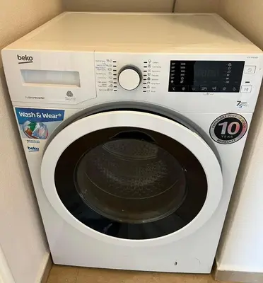 a white washing machine with a box on top at Rio Sunny 2BDR Apt near NDK - Metro - non-stop paid public Parking in Sofia