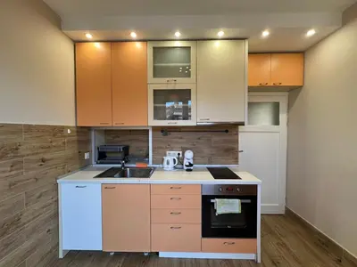 a kitchen with orange and white cabinets and a sink at Rio Sunny 2BDR Apt near NDK - Metro - non-stop paid public Parking in Sofia