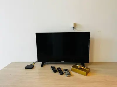 a flat screen tv sitting on top of a wooden floor at Little Jack With Terrace in Sofia