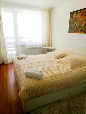 a bedroom with a bed with two towels on it at VIP Apartment Belvedere Club in Bansko