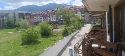 a view of a street with benches and buildings at VIP Apartment Belvedere Club in Bansko