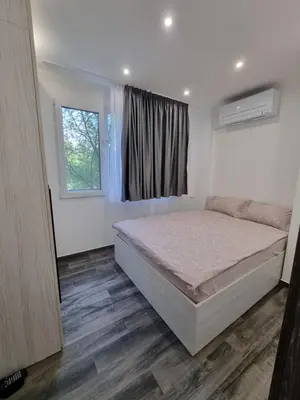 a bedroom with a bed and a window at Apartment's Ortakchiev in Sofia