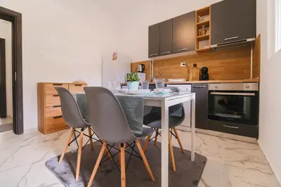 a kitchen with a table and chairs in a room at Apartment in the city center in Plovdiv