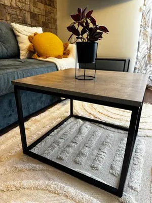 a wooden coffee table in a living room at Апартамент НИА in Velingrad